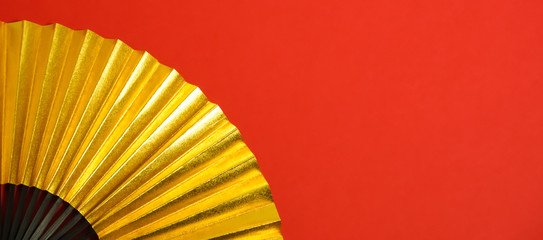 Japanese traditional background material. 　新春　お祝い、年賀、正月素材　金色の扇子のクローズアップ　背景素材