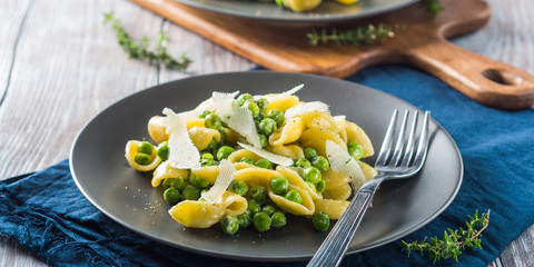 Italian orecchiette pasta with peas, cream and pecorino cheese