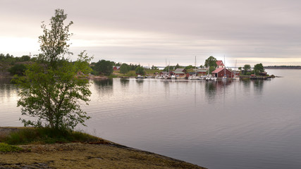 Fototapeta na wymiar Small village with red buildings in Finnish archipelago