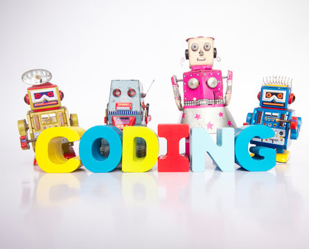 a team of toy robots with the word coding isolated