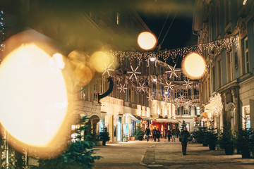 Graz city streets advent Christmas decorations by night. Shot between Christmas lights. - 231668108