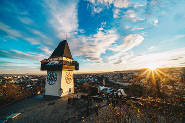 Graz clock tower and city symbol on top of Schlossberg hill at sunset