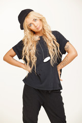 blond swag girl in fashionable black look stands on white isolated. stylish woman wears trendy clothes. fashion, style.