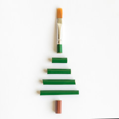 Flat lay of art brush in form of christmas tree abstract.
