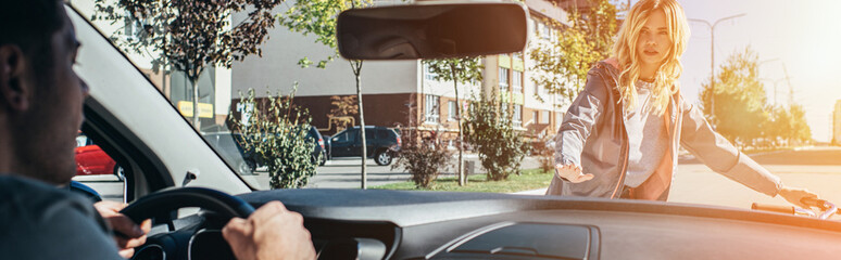 young woman quarreling with car driver while crossing road © LIGHTFIELD STUDIOS