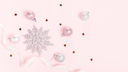 Christmas holiday composition. Festive creative gold silver pattern, xmas pink decor holiday ball with ribbon, snowflakes on pink background. Flat lay, top view