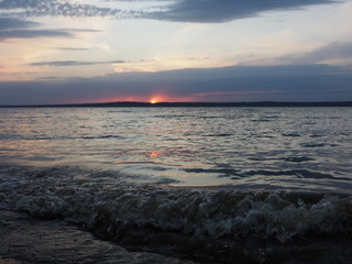 Sunset. On the big river. Coast. Beautiful clouds. Waves. Summer. Russia, Ural, Perm region