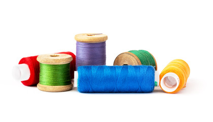 Multi-colored threads on spools.