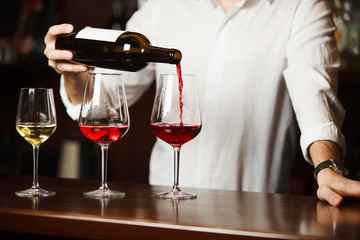 Sommelier pouring different types of fine wine