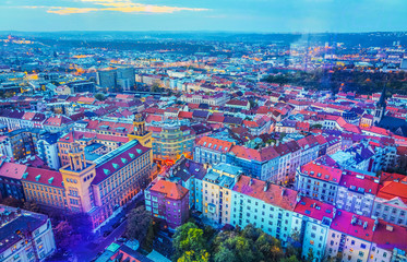 Obraz premium Top view of Prague from observation deck through window glass. Autumn city at dusk.