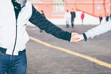 close up hands of lovely couple walking together on street which  Man hand comfort , support ,respect and trust concept.