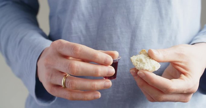 Young Christian woman holds bread and wine, the elements for Communion.