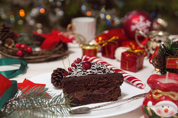 Fototapeta na wymiar Slice of sweet chocolate cake for Christmas Eve.