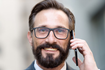 Portrait of handsome man smiling and talking on the phone