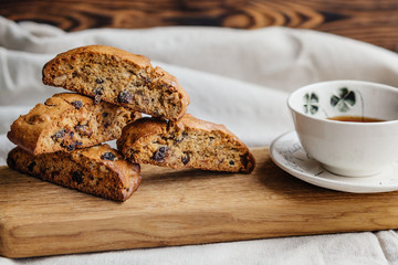Italian biscotti cookies with a cup of black tea on a light tablecloth. cozy photo