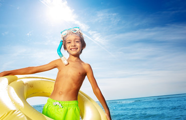 Happy boy with scuba mask and swimming ring