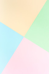 Background pastel colors: pink, yellow, blue, green. Geometric pattern papers. Minimal concept. Flat lay, Top view. 