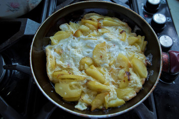 Freid potatoes . Potato fries with egg. Potato fry in the pan with a shellfish.