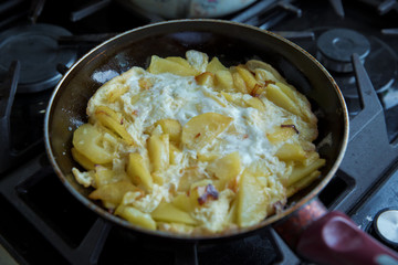 Freid potatoes . Potato fries with egg. Potato fry in the pan with a shellfish.