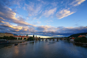 Famous Prague Charles bridge and Vltava river with ships and Old Praha city historic panorama landscape view