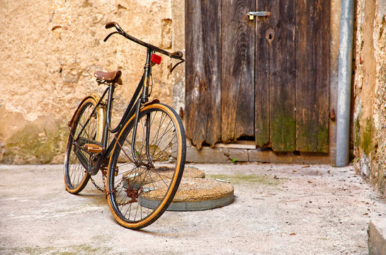 Old retro bicycle on vintage street in Croatia background aged