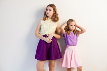 two fashionable girls sisters in beautiful clothes portrait