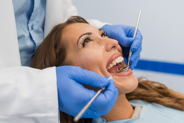 Professional dentist examining teeth. Close up