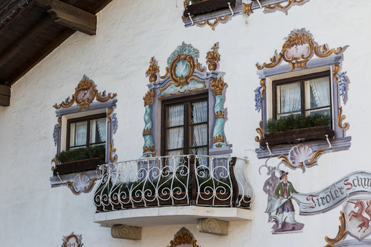 Traditional ornamented painted facade and balcony of Tyrolean building in Seefeld