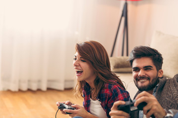 Couple playing video games and having fun