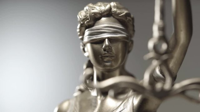 4k Lady Justice zoom in close up dolly shot - law concept shallow depth of field
