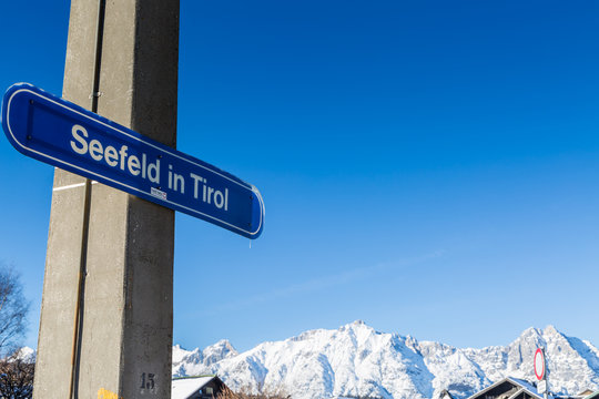 Seefeld gateway sign with snow covered mountains in the background