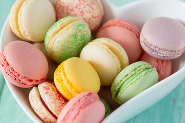colorful macaroons on turquoise surface