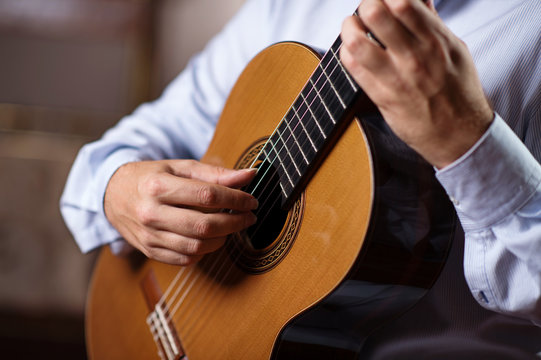 Close up of guitarist hand playing classical guitar. Selective focus, shallow depth of field.
