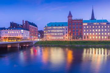 View of the night city reflected in water. Malmo cityscape, Scania, Sweden