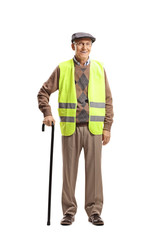 Elderly man standing with a cane and wearing safety vest