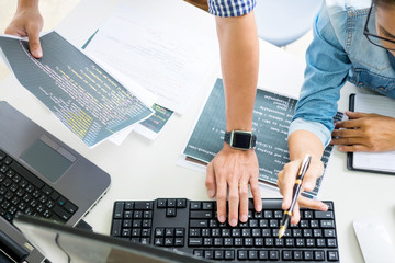 Asian team Outsource Developer Looking Screen Programming Code Working with Laptop Computer...