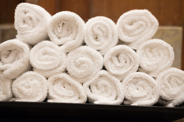 Obraz na płótnie Canvas Rolls of white cotton towel in bedroom.