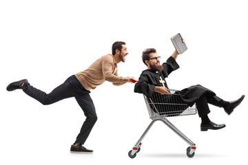 Young man pushing a priest in a shopping cart