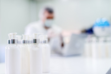 Picture of lotion bottles on production line. Bottles of cosmetic products in factory production...