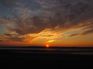 Sunset. On the big river. Coast. Beautiful clouds. Summer. Russia, Ural, Perm region