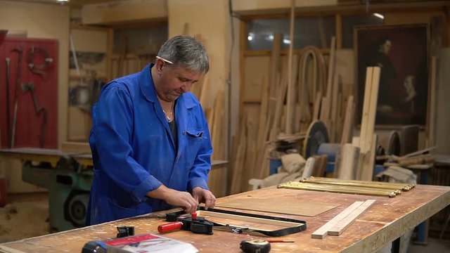 Assembling the wooden frame on the carpentry table in the workshop