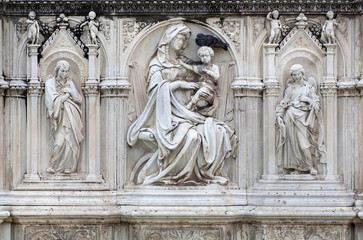 Fototapeta na wymiar Beautiful sculptures of Mother of God and angels on front of the 15th century fountain Fonte Gaia in Siena, Italy. UNESCO World Heritage Site