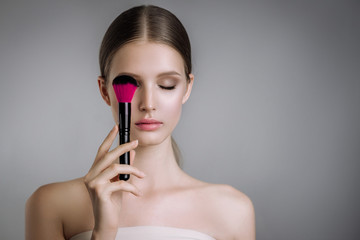 beauty portrait beautiful girl posing with makeup brushes 