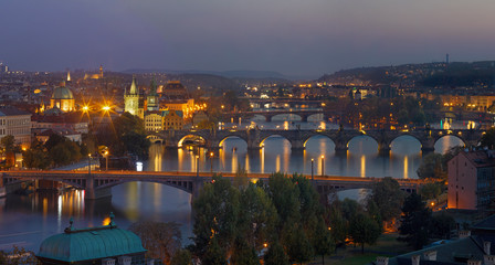 Fototapeta na wymiar Prague - The panorama of the city with the bridges at dusk.