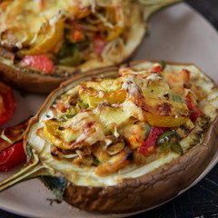 Autumn food with fresh vegetables, quick lunch: eggplant stuffed with tomatoes and cheese. The concept of healthy and vegetarian food.