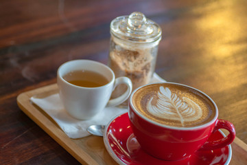Latte Hot Coffee in Red Coffee Cup With morning sun, light fair