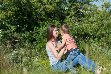 Fototapeta premium mom and young boy son play park love