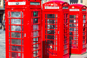 Fototapeta na wymiar Old red telephone booths Royal mile street in Edinburgh