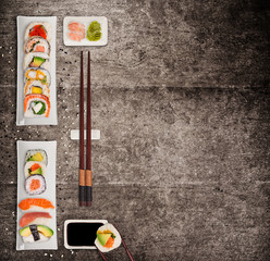 Traditional japanese sushi pieces on rustic concrete background.