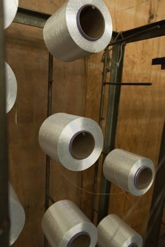 Silver colored thread spools in industry
